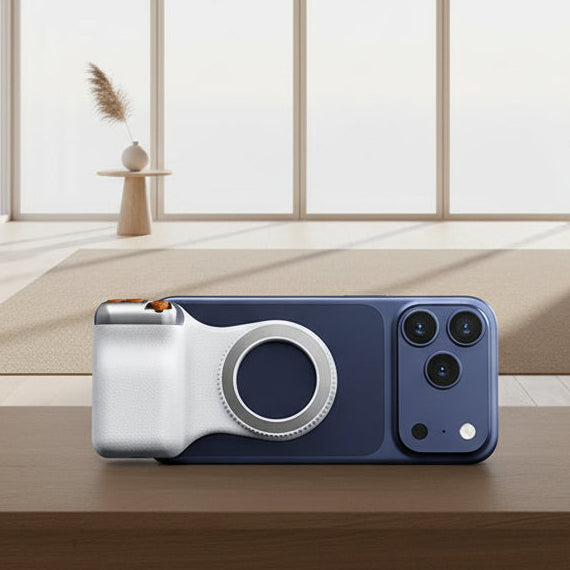 Smartphone with a camera lens cover on a wooden table in a bright room with large windows.